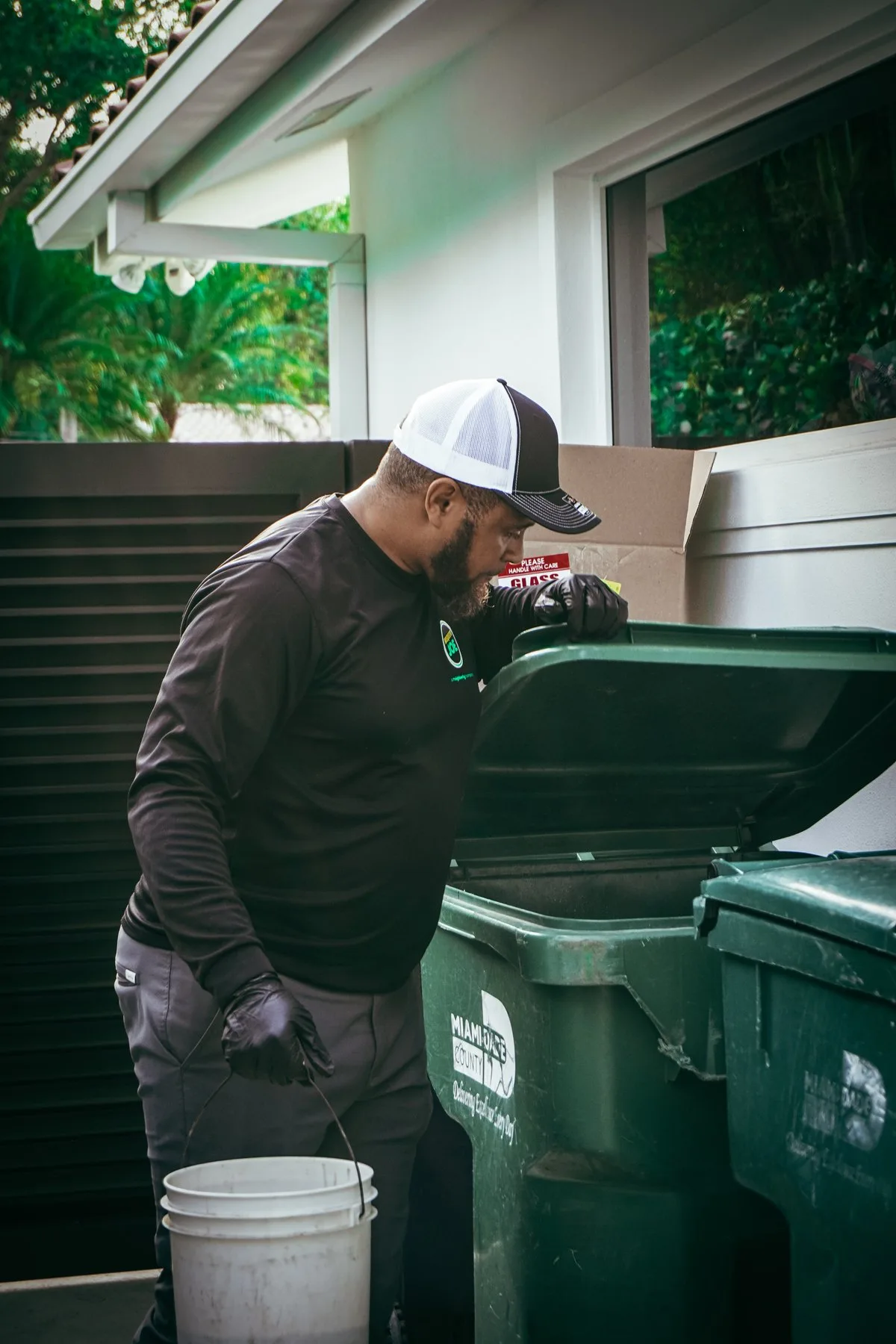 A technician inspecting bins for standing water