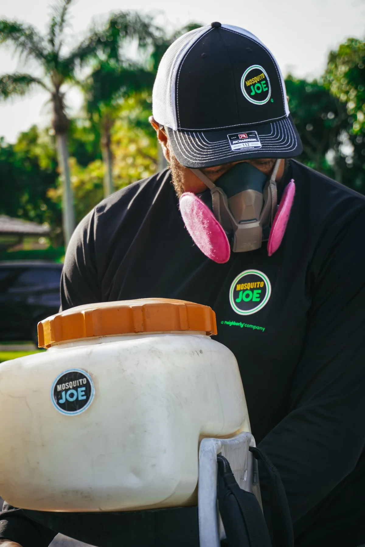 A technician using a backpack sprayer
