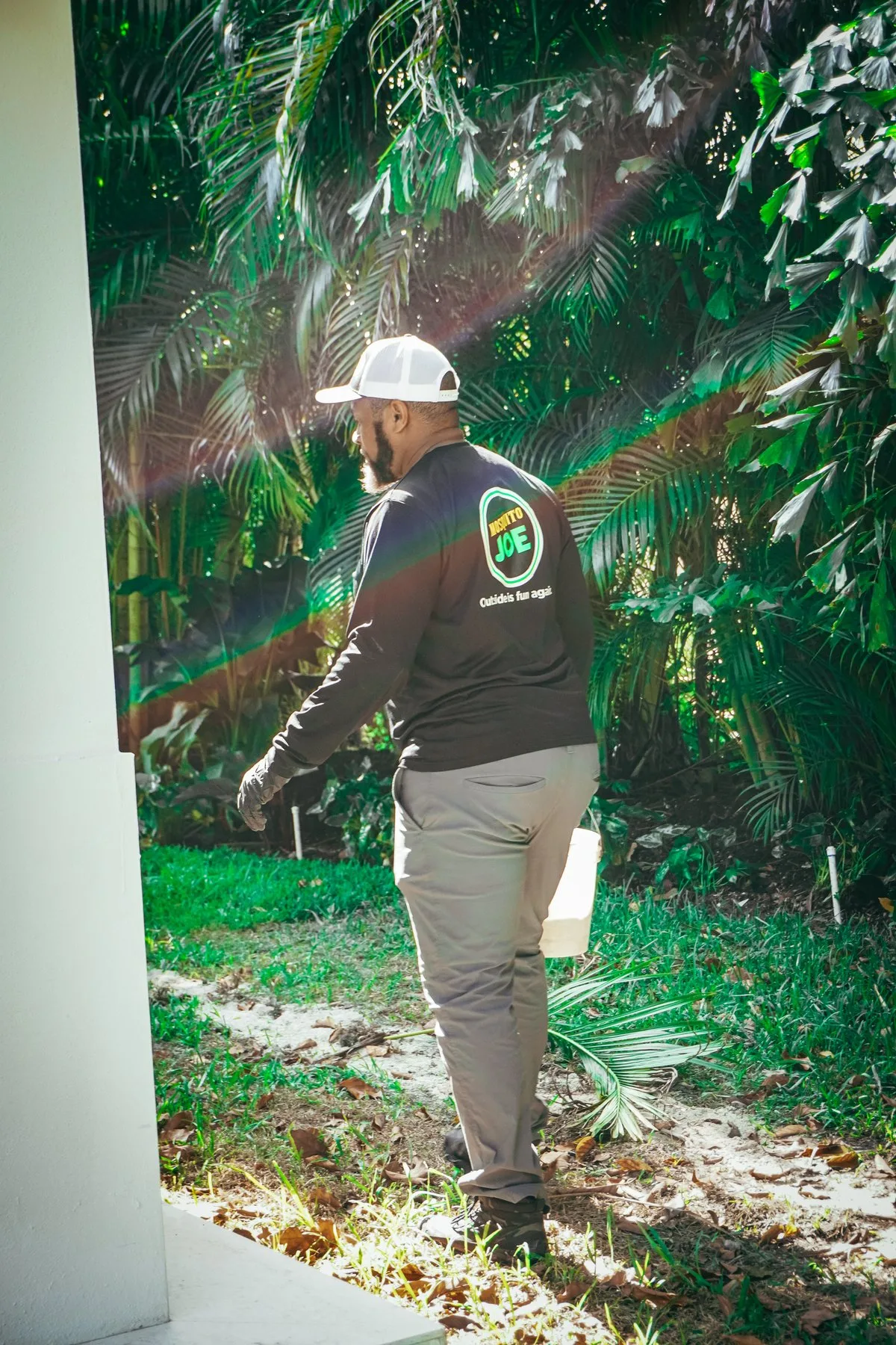 A technician treating dense foliage
